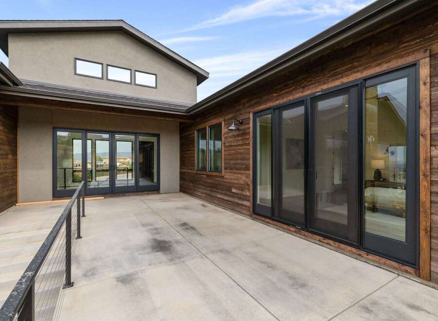 Experience modern living with this stunning property featuring expansive glass doors that seamlessly connect indoor and outdoor spaces.