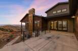 Experience modern luxury in this stunning home, featuring a striking rusted metal chimney and rich wood siding.