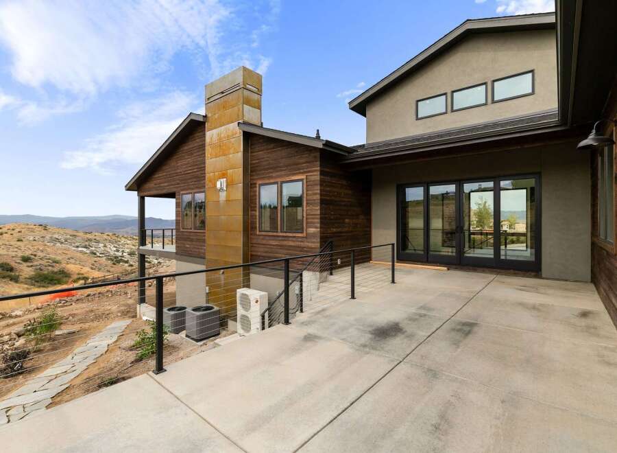 Experience modern living with this stunning home featuring expansive glass doors that open to breathtaking mountain views.