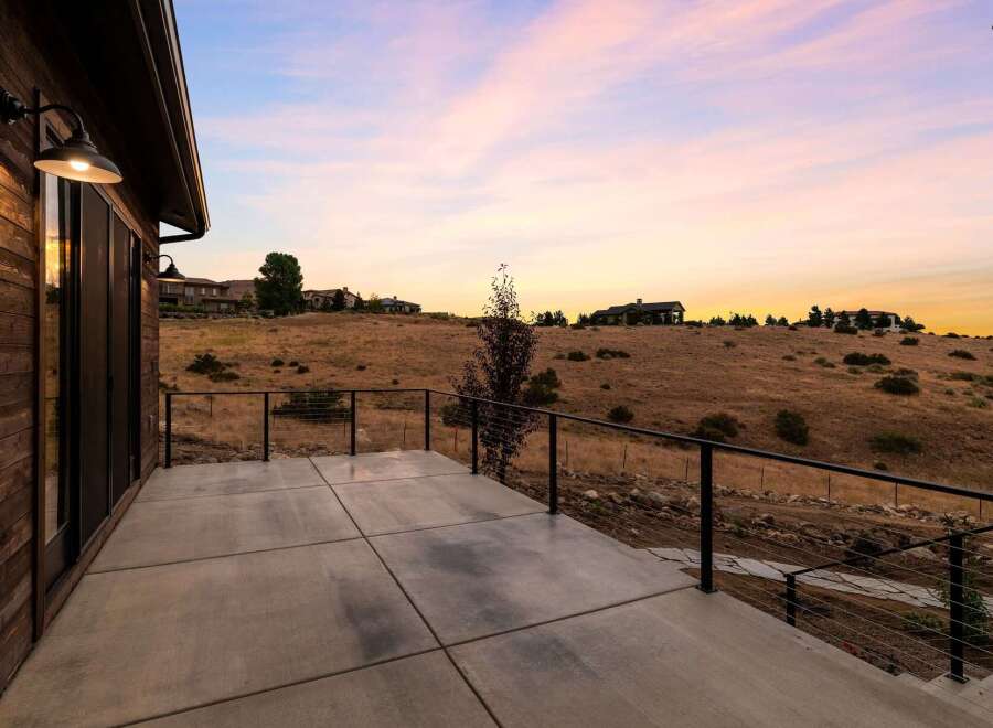 Experience breathtaking sunset views from this expansive concrete patio, perfect for outdoor entertaining.