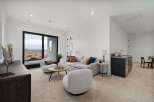 Experience modern living in this stylish living area, featuring plush seating and a sleek wet bar perfect for entertaining.