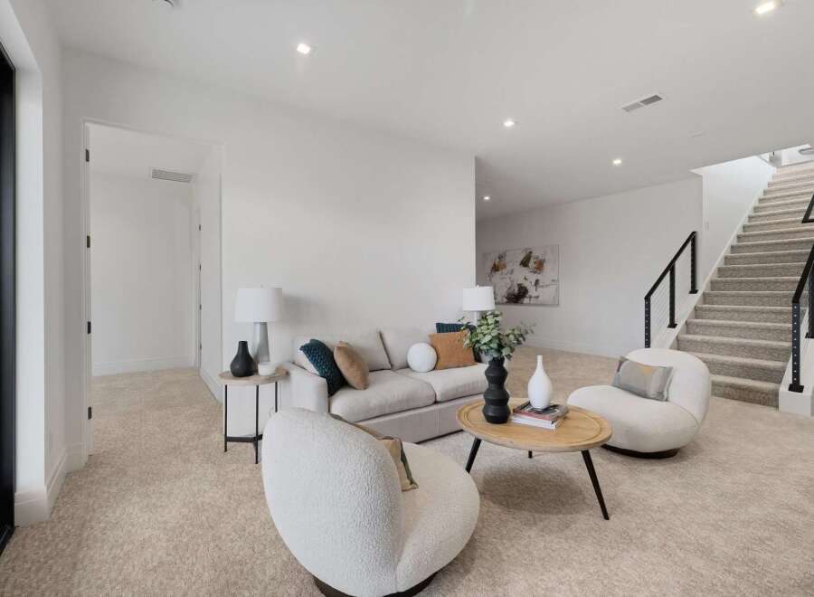 Step into this inviting living space featuring a plush sofa and two cozy armchairs, perfect for relaxation.