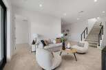 Step into this inviting living space featuring a plush sofa and two cozy armchairs, perfect for relaxation.