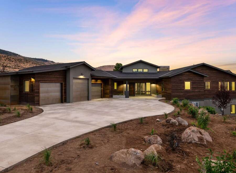 Experience modern luxury in this stunning contemporary home, featuring a striking wood and stucco exterior that blends seamlessly with the natural landscape.