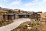 Experience luxury living in this stunning modern home nestled in a picturesque hillside setting.
