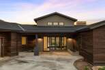 Experience modern living in this stunning home featuring rich wood siding and a sleek, contemporary design.