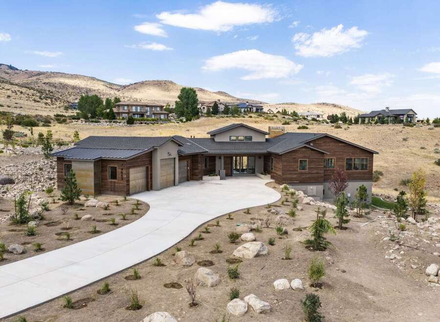 Experience luxury living in this stunning modern home nestled in a picturesque hillside setting.