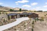 Experience luxury living in this stunning modern home nestled in a picturesque hillside setting.