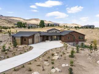 Experience luxury living in this stunning modern home nestled in a picturesque hillside setting.