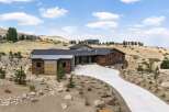 Discover modern luxury in this stunning hillside residence, featuring a striking wood and metal exterior that complements the natural desert landscape.