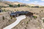 Experience luxury living in this stunning modern home, nestled in a serene hillside landscape.