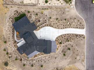 Discover this stunning modern home featuring a multi-level dark shingle roof and a sleek metal roof accent.