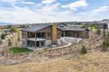 Experience modern luxury in this stunning multi-level home, featuring a striking wood and stone exterior that blends seamlessly with the natural landscape.