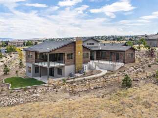 Experience modern luxury in this stunning multi-level home, featuring a striking wood and stone exterior that blends seamlessly with the natural landscape.