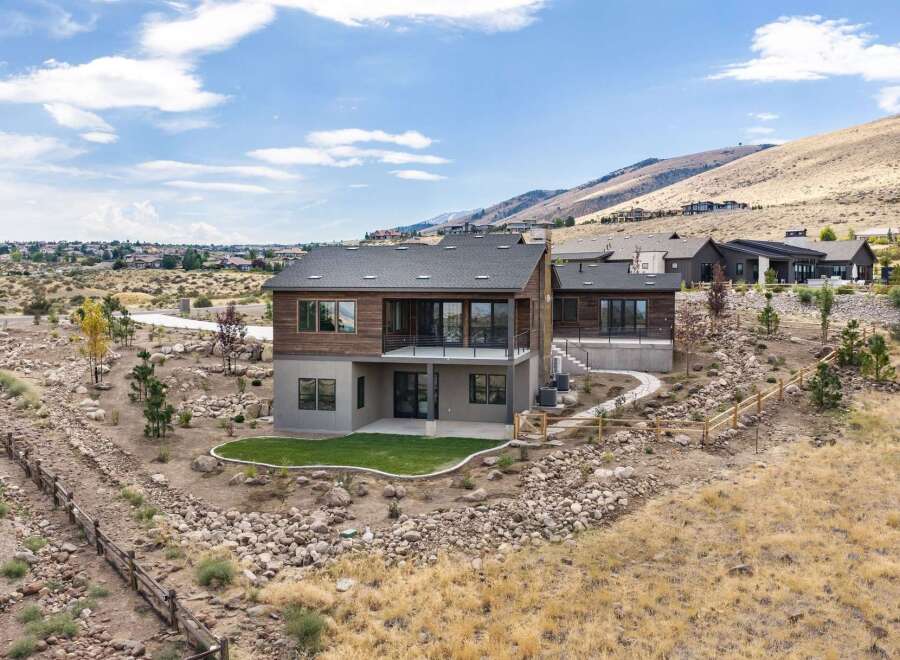 Experience modern luxury in this stunning home, featuring a striking wood and stucco exterior that complements the natural desert landscape.
