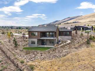 Experience modern luxury in this stunning home, featuring a striking wood and stucco exterior that complements the natural desert landscape.