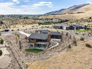 Discover modern luxury living in this stunning home nestled in a picturesque hillside community.