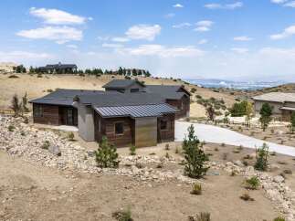Discover modern luxury in this stunning home, featuring a striking architectural design with natural wood and metal accents.
