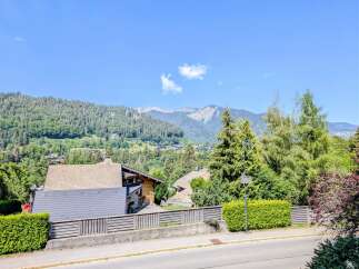 Nestled amidst lush greenery and offering breathtaking mountain views, this property boasts charming chalets with traditional wooden architecture.