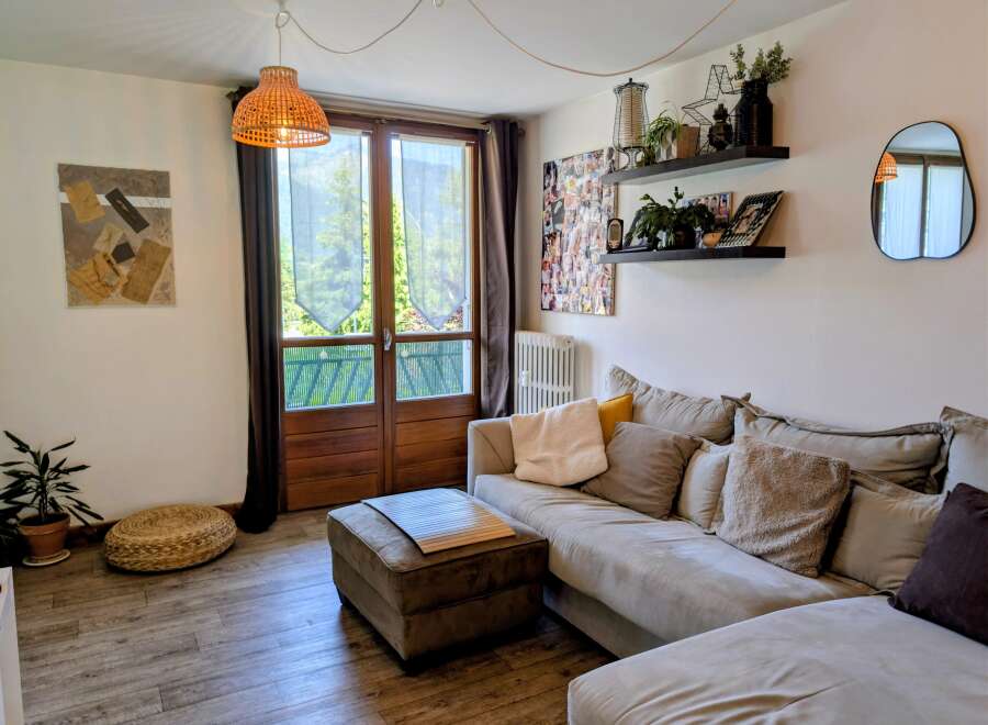 This living room features a comfortable sectional sofa adorned with plush pillows, perfect for relaxation.