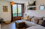 This living room features a comfortable sectional sofa adorned with plush pillows, perfect for relaxation.