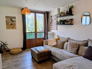 This living room features a comfortable sectional sofa adorned with plush pillows, perfect for relaxation.