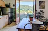 Experience breathtaking mountain views from this charming dining area, featuring a rustic wooden table perfect for family meals.