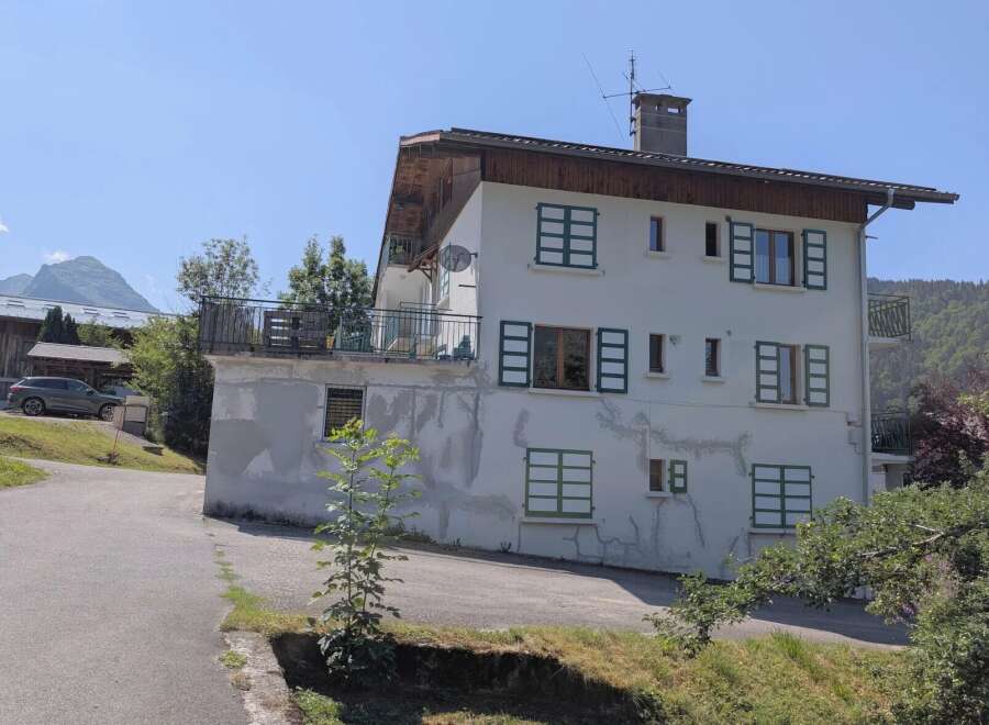 Discover this charming multi-story residence nestled in a serene mountain landscape.