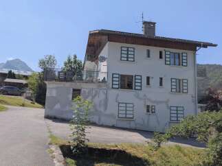 Discover this charming multi-story residence nestled in a serene mountain landscape.