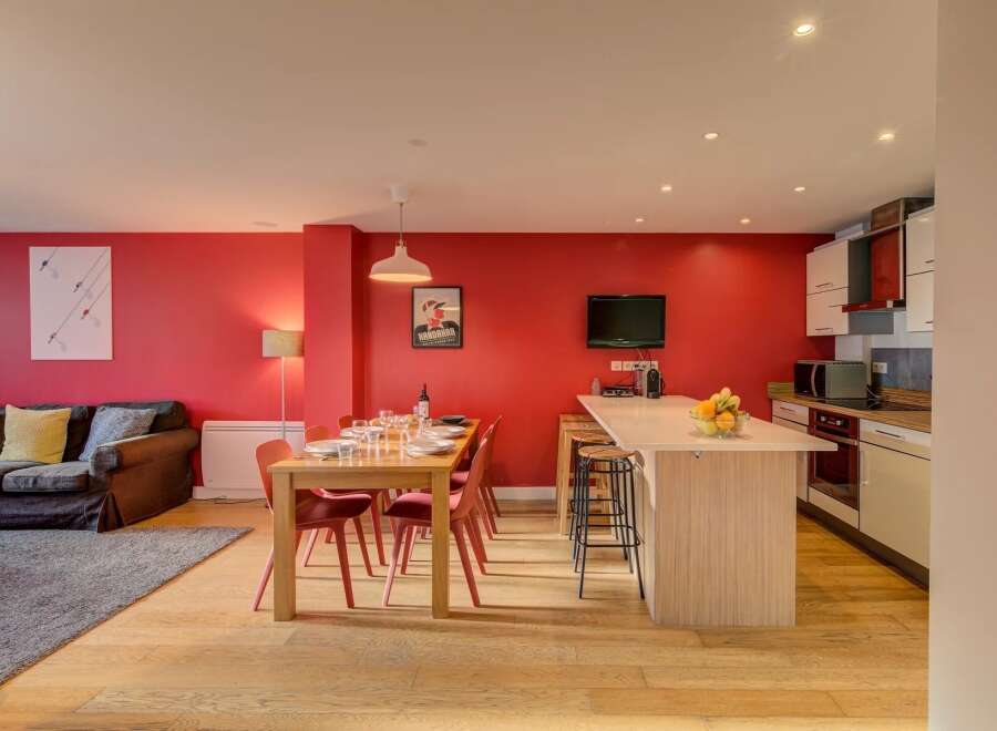 Experience modern living in this vibrant open-plan space, featuring a sleek kitchen island perfect for casual dining and entertaining.