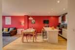 Experience modern living in this vibrant open-plan space, featuring a sleek kitchen island perfect for casual dining and entertaining.