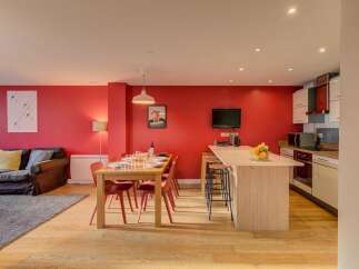 Experience modern living in this vibrant open-plan space, featuring a sleek kitchen island perfect for casual dining and entertaining.