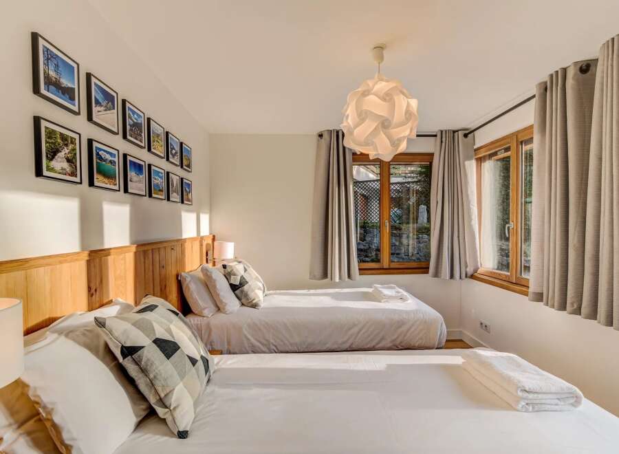 This charming bedroom features two comfortable beds, perfect for families or groups.