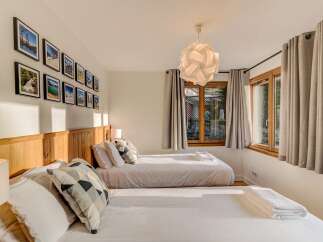 This charming bedroom features two comfortable beds, perfect for families or groups.