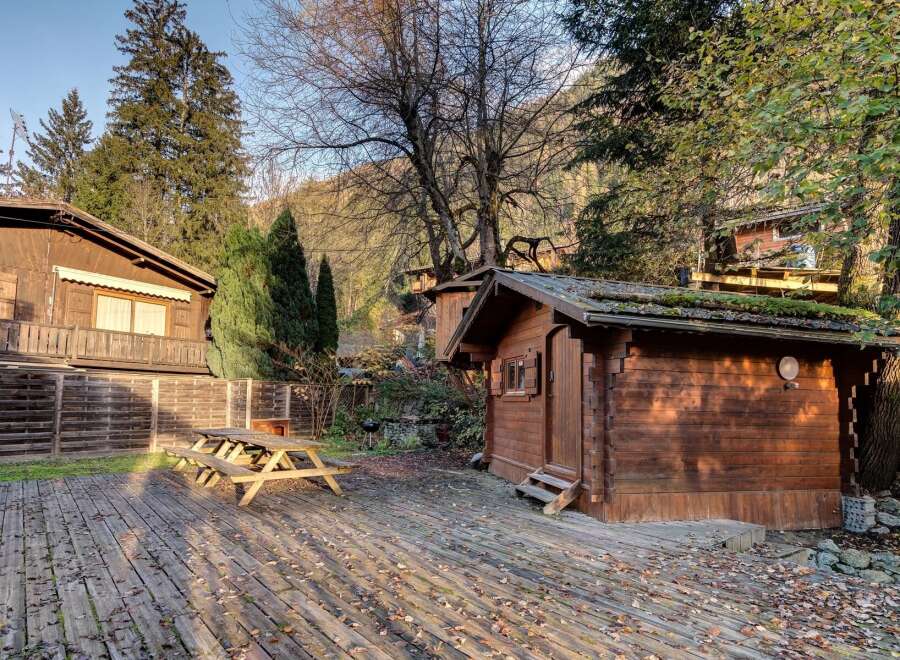 Experience rustic charm in this mountain retreat featuring a cozy wooden cabin and a spacious deck perfect for outdoor gatherings.