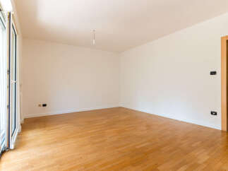 Step into this bright and airy empty room, featuring a beautiful hardwood floor that adds warmth and elegance.