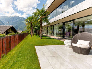 Experience modern luxury with this stunning property featuring expansive glass walls that seamlessly blend indoor and outdoor living.