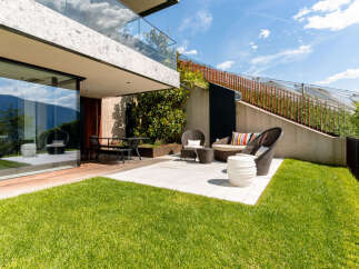 Experience modern luxury with this stunning outdoor living space, featuring a sleek patio area perfect for entertaining.