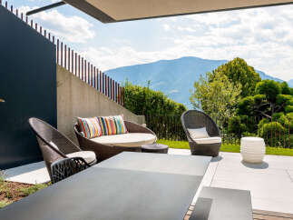 Experience luxurious outdoor living with this stunning patio featuring comfortable wicker seating and a modern dining set.