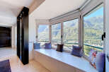 Enjoy breathtaking mountain views from this stunning bay window seating area, perfect for relaxation and soaking in the scenery.