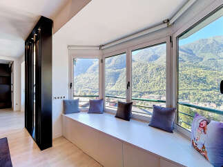 Enjoy breathtaking mountain views from this stunning bay window seating area, perfect for relaxation and soaking in the scenery.