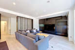 Experience modern living in this spacious living room, featuring a large, comfortable sectional sofa perfect for gatherings.