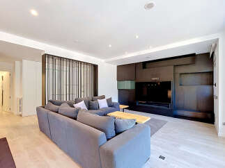 Experience modern living in this spacious living room, featuring a large, comfortable sectional sofa perfect for gatherings.