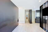 Discover modern living in this stylish apartment featuring a sleek, dark-toned feature wall and a minimalist aesthetic.