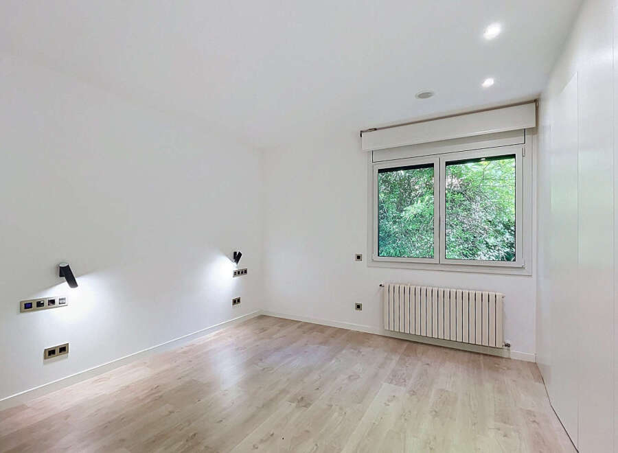 Discover this bright and airy room featuring a large window with lush green views, perfect for bringing the outdoors in.