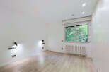 Discover this bright and airy room featuring a large window with lush green views, perfect for bringing the outdoors in.