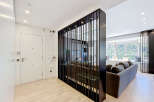 This modern apartment features a stylish entryway with a sleek white door and integrated storage.