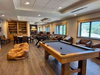 Experience ultimate relaxation and entertainment in this inviting common area, featuring a billiards table and foosball for endless fun.