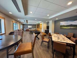 This spacious common area offers a variety of entertainment options, including a pool table and foosball table, perfect for group activities.
