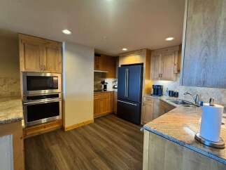 Experience modern convenience in this beautifully appointed kitchen, featuring a sleek stainless steel microwave and oven combination.